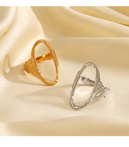 Detailed view of hammered texture on irregular cutout gold and silver rings on silk