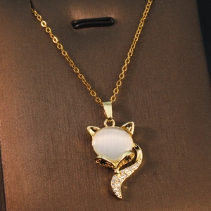 Macro shot of fox pendant necklace featuring cat eye stone and black-white zircons