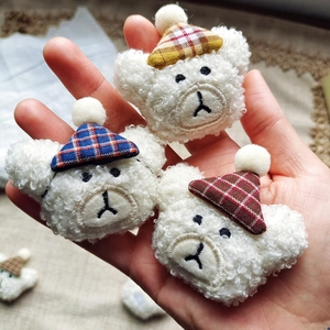 Detailed view of white plush bear heads with colorful plaid hats in a hand-held shot