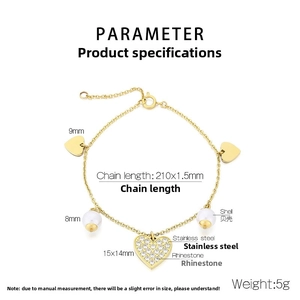 Detail of gold stainless steel bracelet with white shell pearls and rhinestone heart charms