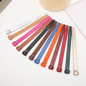 Detail of 11 assorted leather wrist straps with metal buckles and adjustable holes