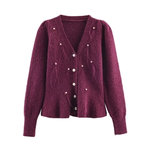 Detailed view of the purple knit cardigan featuring pearl buttons and delicate feather accents