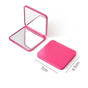 Pink portable mini folding double-sided makeup mirror with 7cm x 6.5cm dimensions