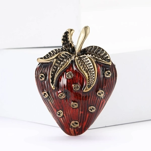 Minimalist red enamel strawberry brooch with gold-tone alloy finish on a white background