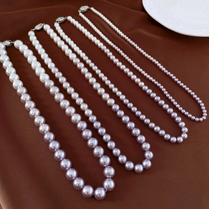 Detail of four sizes of pearl necklaces with S925 sterling silver clasp on silk