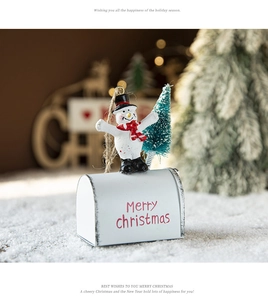 Festive snowman and Christmas tree figurine on a white Merry Christmas mailbox stand