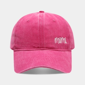 Detail of the white mimi embroidery on a washed rose pink cotton baseball cap