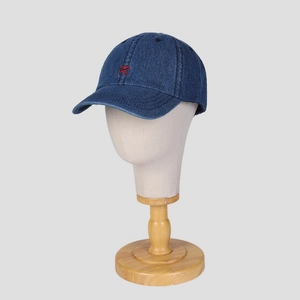 Classic navy denim baseball cap with red embroidered R letter displayed on a model head