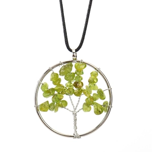 Detailed wire-wrapped silver tree of life pendant with green natural stone chips and cord