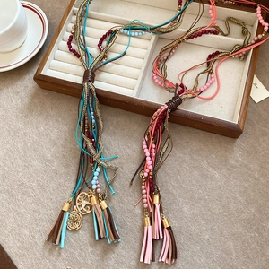 Detail of multi-layered bohemian fringe necklace with colorful beads and leather tassels