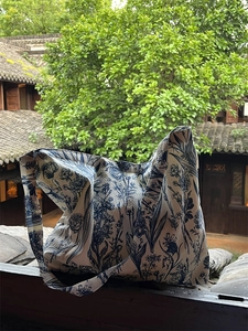 Chinese style blue floral print large capacity canvas tote bag against a garden background