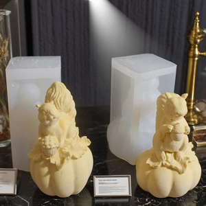 Silicone squirrel and pumpkin mold set with finished resin craft on marble surface