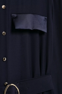 Detail of navy shirt dress with golden buttons and a waist belt with ring buckle