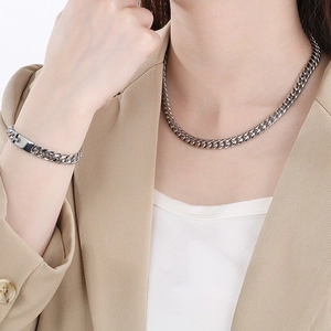 Polished 8mm silver stainless steel Cuban chain necklace and bracelet set on model
