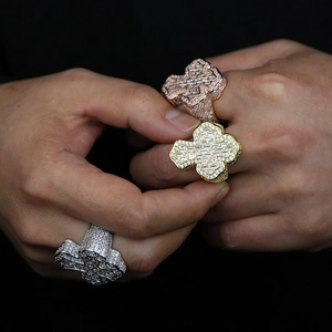 Close-up of hip hop cross rings with sparkling zircons in gold, silver, and rose gold