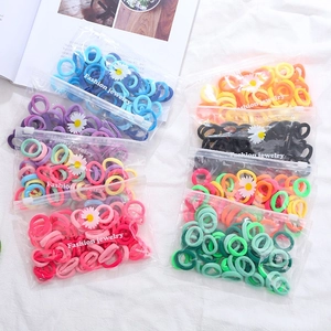 Macro shot of colorful high-elastic hair ties in sets with transparent daisy packaging
