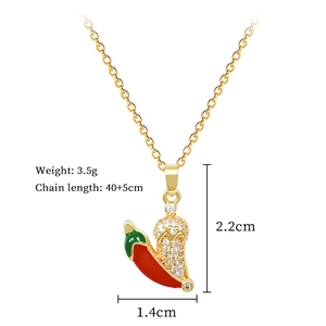 Detailed view of chili pendant with red enamel and pavé zircons on gold chain necklace