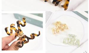 Detail of wave-shaped acetate hair claws in tortoise shell, cream, and pale green marble