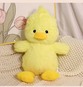 Close-up of yellow duck plush toy showing soft texture and detailed sewing craftsmanship