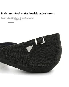 Detail of adjustable stainless steel buckle on herringbone wool blend beret hat