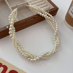 Three-strand twisted cream pearl necklace with elegant silver lobster clasp finish