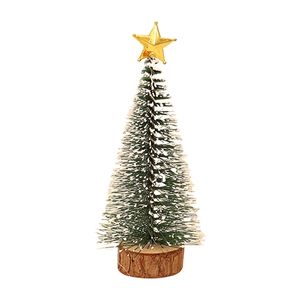 Miniature green Christmas tree with gold star, wooden base and artificial snow effect