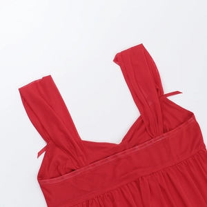 Detail of red mesh strap with a delicate bow on a sexy mesh top for women