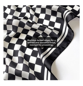 Detail of checkered silk scarf showing precise machine-stitched edges and soft texture