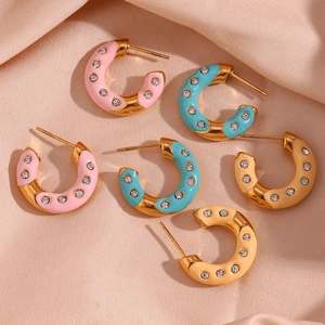 Detailed macro view of 18K gold plated donut earrings with colorful enamel and crystals