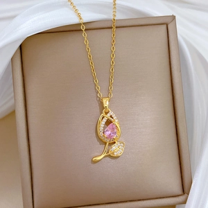 Detail of gold tulip necklace featuring pink gemstone and sparkling zircon crystals