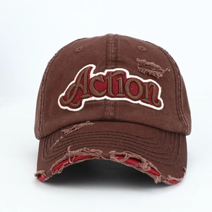 Macro detail of Action 3D embroidery and distressed ripped elements on coffee baseball cap