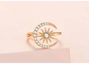 Detailed shot of gold sun and moon open ring with sparkling white zircon inlay