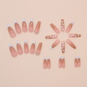 Detail of pink French coffin press-on nails with white hearts and colorful rhinestones