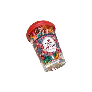 Colorful disposable rubber band set in transparent herbal tea style cup with red lid