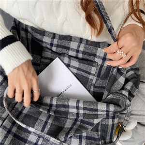 Detail shot of the large capacity black and grey plaid wool tote bag interior and fabric