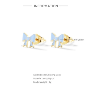 Detail view of 925 sterling silver bow earrings with light blue enamel dripping oil