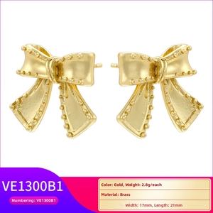 Detail view of gold-plated brass bow earrings showing dimensions 17mm x 21mm and beaded edge
