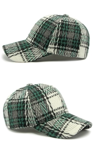 Detail view of the vintage plaid pattern and thick tweed texture of the baseball cap