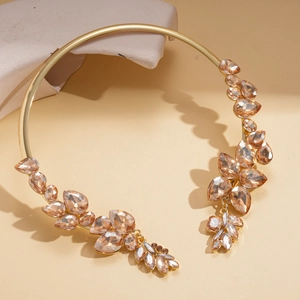 Close-up of vintage gold choker with champagne crystals in baroque leaf pattern