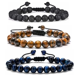 Detailed shot of tiger eye, volcanic stone and blue tiger eye beaded woven bracelets