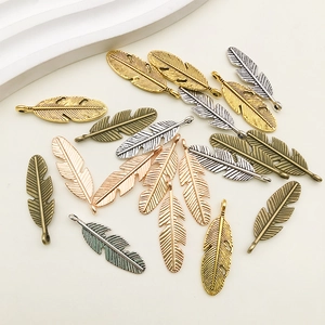 Assorted alloy feather wing pendants in gold, silver, and bronze for DIY jewelry making