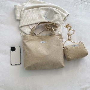 Detail of corduroy tote bag and mini chain pouch set with fashion fabric label