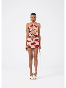 Detailed view of backless halter mini dress with 3D floral accent and rose print design
