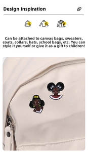 Detail of Afro-style female enamel pins showing hip-hop cartoon design on a suit lapel