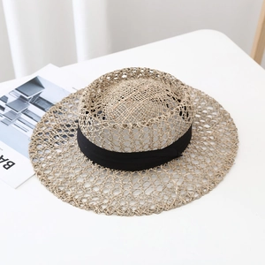 Detailed view of hand-woven seagrass sun hat featuring breathable hollow-out straw texture