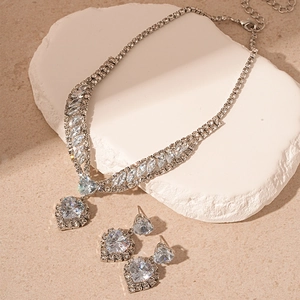 Luxury silver heart pendant necklace and earring set with shimmering cubic zirconia stones