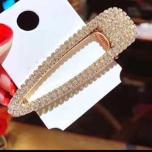 Elegant gold hollow rectangle hair clip with sparkling rhinestones on display card