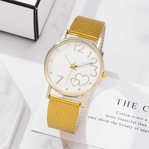 Women's fashion watch with gold mesh strap and heart pattern white dial on marble