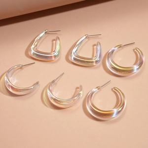 Detailed macro shot of 6 iridescent acrylic geometric earrings with metal needles