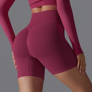 Detail view of high-waisted seamless scrunch butt yoga shorts in deep magenta knit